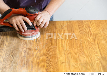 worker polishes table using polishing machine worker polishes table using polishing machine 140984937