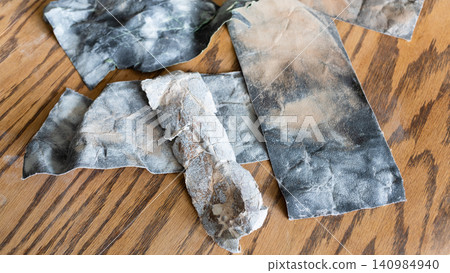 used pieces of sandpaper on sanded wood close-up used pieces of sandpaper on sanded wood close-up 140984940