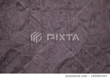 Wrinkled brown fabric texture background with creases and subtle grain for design use Wrinkled brown fabric texture background with creases and subtle grain for design use 140985447