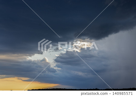 Storm clouds gathering with light breaking through Storm clouds gathering with light breaking through 140985571