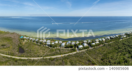 American waterfront houses in rural US suburbs. View from above of large residential homes in island small town Boca Grande on Gasparilla Island in southwest Florida American waterfront houses in rural US suburbs. View from above of large residential homes in island small town Boca Grande on Gasparilla Island in southwest Florida 140985606