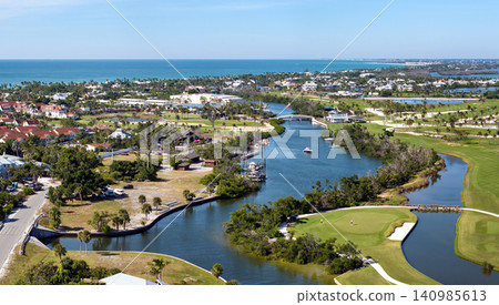 American waterfront houses in rural US suburbs. View from above of large residential homes in island small town Boca Grande on Gasparilla Island in southwest Florida American waterfront houses in rural US suburbs. View from above of large residential homes in island small town Boca Grande on Gasparilla Island in southwest Florida 140985613