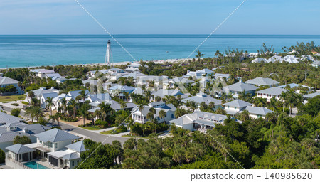 Large residential homes and tall lighthouse in island small town Boca Grande on Gasparilla Island in southwest Florida. American waterfront houses in rural US suburbs Large residential homes and tall lighthouse in island small town Boca Grande on Gasparilla Island in southwest Florida. American waterfront houses in rural US suburbs 140985620