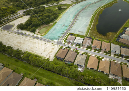 Real estate development with tightly located family houses under construction in Florida suburban area. Concept of growing american suburbs 140985660