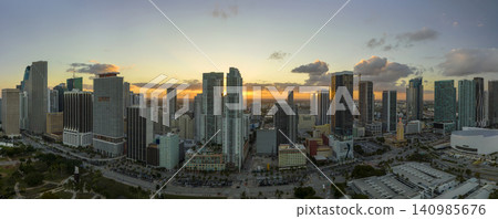 Aerial view of downtown office district of of Miami Brickell in Florida, USA at sunset. High commercial skyscraper buildings and urban traffic in modern american megapolis Aerial view of downtown office district of of Miami Brickell in Florida, USA at sunset. High commercial skyscraper buildings and urban traffic in modern american megapolis 140985676