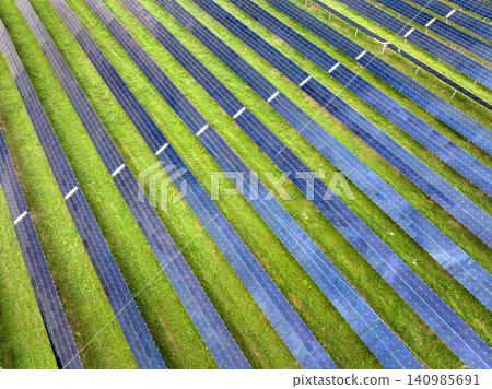 View from above of photovoltaic power plant with many rows of solar panels for producing clean electrical energy. Concept of renewable electricity with no air pollution 140985691