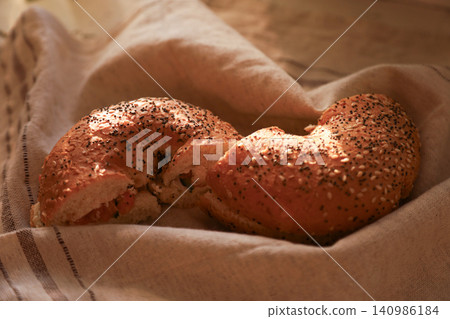 Sesame seed bagels with salmon filling on linen cloth Sesame seed bagels with salmon filling on linen cloth 140986184