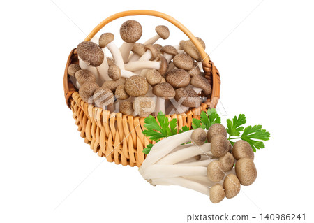 Brown beech mushrooms or Shimeji mushroom in wicker basket isolated on white background with full depth of field. Brown beech mushrooms or Shimeji mushroom in wicker basket isolated on white background with full depth of field. 140986241