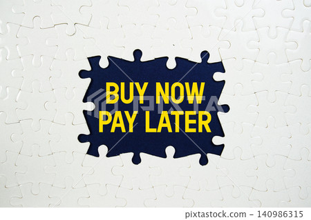 Jigsaw puzzle with a missing piece with "Buy Now Pay Later" on navy blue background Jigsaw puzzle with a missing piece with "Buy Now Pay Later" on navy blue background 140986315