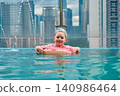A girl swims in a rooftop pool in Kuala Lumpur 140986464