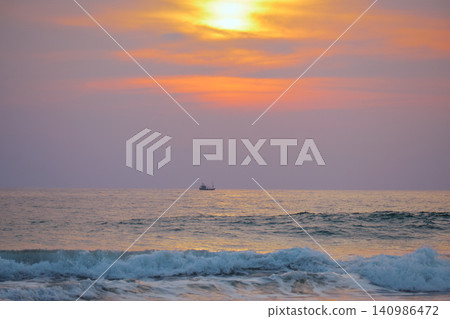 Stunning sunset over Indian Ocean on Hikkaduwa Beach Sri Lanka with calm waves Stunning sunset over Indian Ocean on Hikkaduwa Beach Sri Lanka with calm waves 140986472