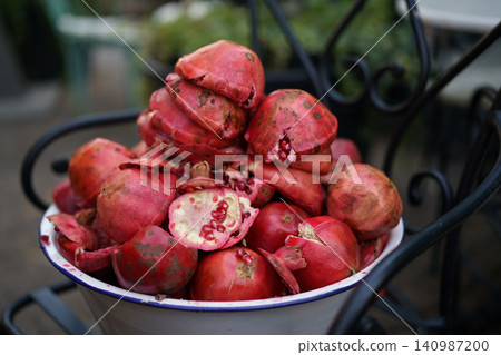 Pan filled with pomegranate peels after being used in juicer to get invigorating drink saturated Pan filled with pomegranate peels after being used in juicer to get invigorating drink saturated 140987200