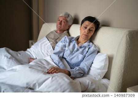 Loneliness and intimacy problems at older age, silent senior woman avoiding contact with partner. Loneliness and intimacy problems at older age, silent senior woman avoiding contact with partner. 140987309