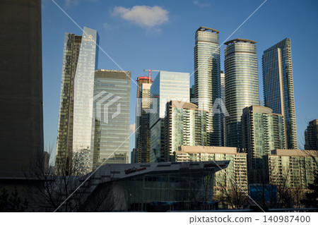 Glass Tower Cluster Rises Against Clear Blue Sky Glass Tower Cluster Rises Against Clear Blue Sky 140987400