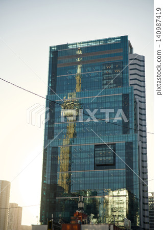 Reflective Tower Shows Crane And City Skyline Reflective Tower Shows Crane And City Skyline 140987419