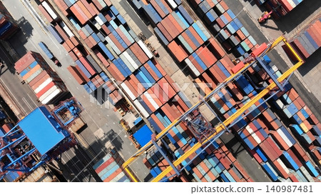 Aerial perspective of container ship loading operations, highlighting maritime cargo handling at busy industrial harbor Aerial perspective of container ship loading operations, highlighting maritime cargo handling at busy industrial harbor 140987481