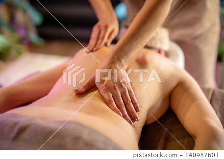 Female health and wellbeing, woman enjoys relaxing massage session in clinic, beauty routine rituals Female health and wellbeing, woman enjoys relaxing massage session in clinic, beauty routine rituals 140987601