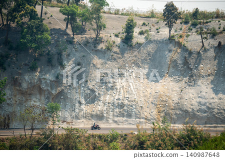 Work to strengthen mountain slope from landslides and rockfall with special metal netting. Work to strengthen mountain slope from landslides and rockfall with special metal netting. 140987648