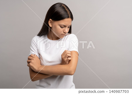 Teen girl having dermatitis, allergic reaction, hormonal problems, scratching itching painful skin Teen girl having dermatitis, allergic reaction, hormonal problems, scratching itching painful skin 140987703