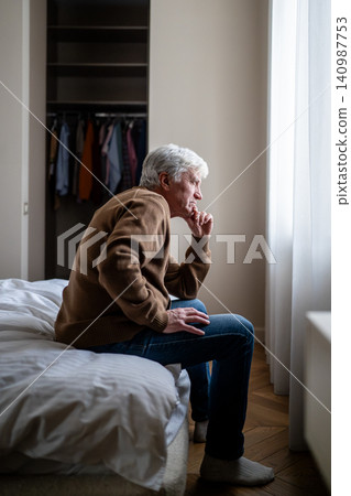 Senior man alone at home with hand over mouth reflecting in fear and apathy. Dementia sick issues Senior man alone at home with hand over mouth reflecting in fear and apathy. Dementia sick issues 140987753