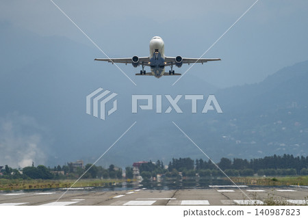 Airplane taking off from the airport, mountains on background. Transportation concept 140987823