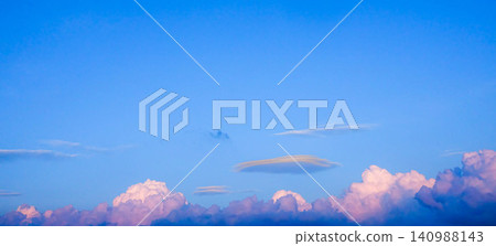 A simple yet wondrous landscape of blue sky and clouds, reflecting the setting sun's light. A simple yet wondrous landscape of blue sky and clouds, reflecting the setting sun's light. 140988143