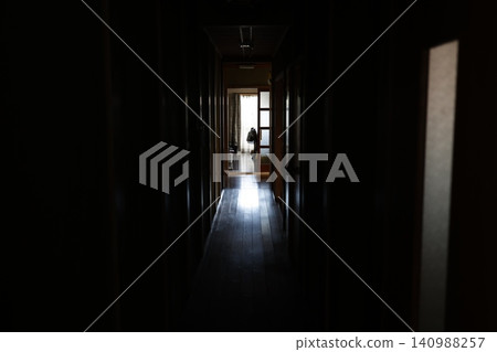 A long, dimly lit corridor with no windows. An old Japanese house. An old house with poor sunlight. A long, dimly lit corridor with no windows. An old Japanese house. An old house with poor sunlight. 140988257