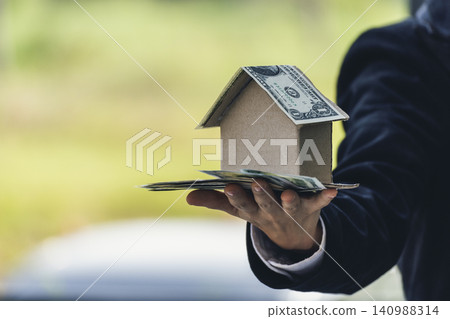 Real estate agent hands holding home business mortgage loan investment property. Hands saving protection home residential concepts. Insurance Agent sale residence ownership household protection care Real estate agent hands holding home business mortgage loan investment property. Hands saving protection home residential concepts. Insurance Agent sale residence ownership household protection care 140988314
