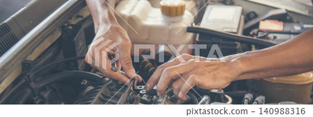 Banner Mechanic man hands repairing car shop. Man hands fixing Car machinery vehicle mechanical service. Panorama open vehicle hood checking up auto mobile. Car maintenance engineer with copy sapce Banner Mechanic man hands repairing car shop. Man hands fixing Car machinery vehicle mechanical service. Panorama open vehicle hood checking up auto mobile. Car maintenance engineer with copy sapce 140988316