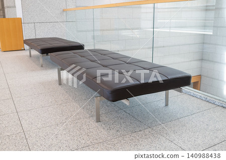 A black bench placed in the lobby (image) A black bench placed in the lobby (image) 140988438