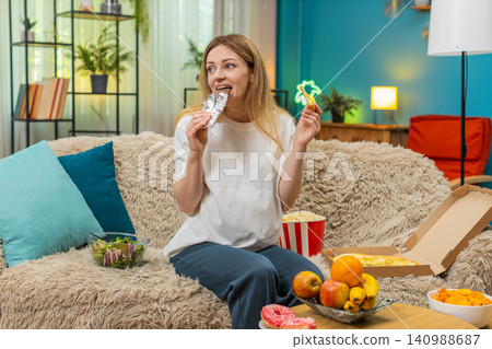 Pregnant woman craves pizza chocolate fruit chips popcorn wants to eat all hunger during pregnancy Pregnant woman craves pizza chocolate fruit chips popcorn wants to eat all hunger during pregnancy 140988687
