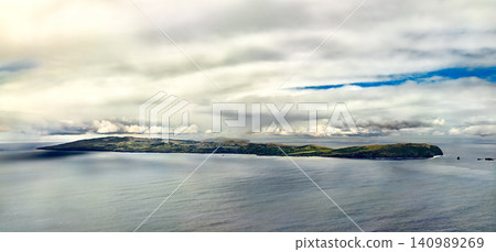 A beautiful panoramic view of Easter Island surrounded by the vast Pacific Ocean under a dramatic cloudy sky, Rapa Nui, Chile 140989269