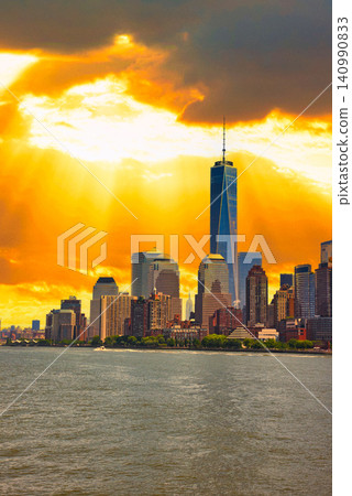 A beautiful sunset view of skyscrapers seen from a sightseeing boat. A beautiful sunset view of skyscrapers seen from a sightseeing boat. 140990833