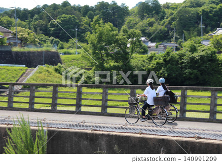 Junior high school students go to school by bicycle Junior high school students go to school by bicycle 140991209