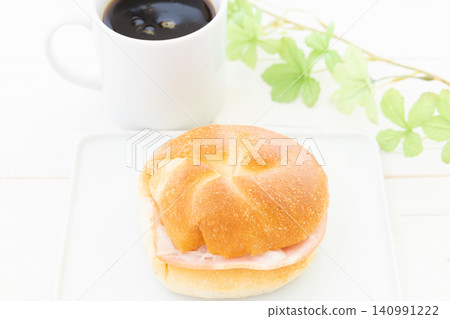 A delicious Kaiser sandwich and coffee for breakfast. A delicious Kaiser sandwich and coffee for breakfast. 140991222