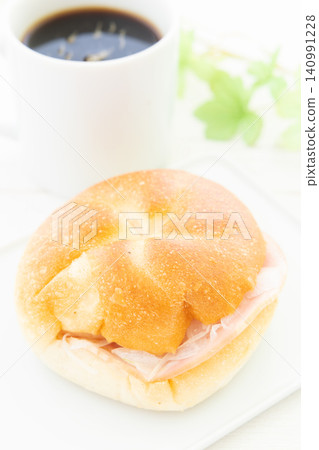 A delicious Kaiser sandwich and coffee for breakfast. A delicious Kaiser sandwich and coffee for breakfast. 140991228