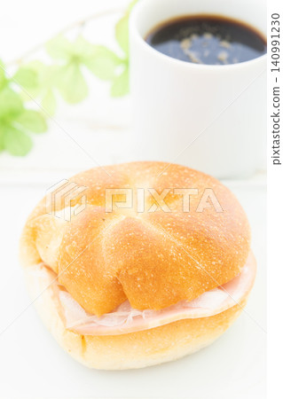 A delicious Kaiser sandwich and coffee for breakfast. A delicious Kaiser sandwich and coffee for breakfast. 140991230
