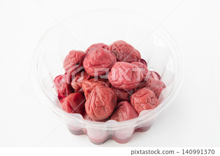 Pickled plums in a clear plastic container Pickled plums in a clear plastic container 140991370