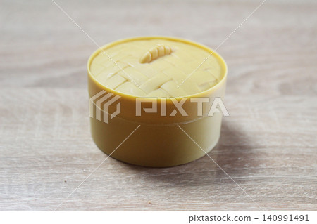 Yellow box with a squishy dumpling on a light background 140991491