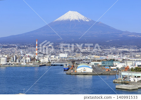 A view of Mt. Fuji and the cityscape of Fuji City from Fujinokuni Tagonoura Minato Park in Fuji City. A view of Mt. Fuji and the cityscape of Fuji City from Fujinokuni Tagonoura Minato Park in Fuji City. 140991533