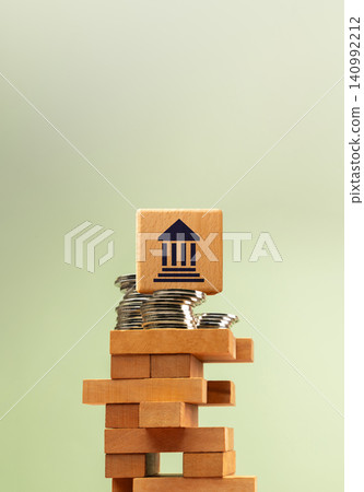 Wooden government bank symbol stacked on unstable blocks with coins, economic finance uncertainty Wooden government bank symbol stacked on unstable blocks with coins, economic finance uncertainty 140992212