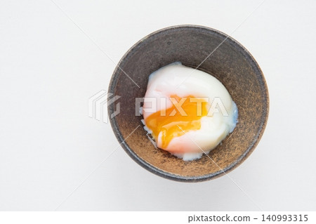 Onsen tamago (soft-boiled egg) with the yolk broken Onsen tamago (soft-boiled egg) with the yolk broken 140993315