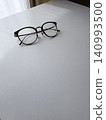 Glasses placed on the desk by the window 140993500