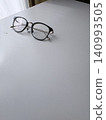Glasses placed on a white desk 140993505