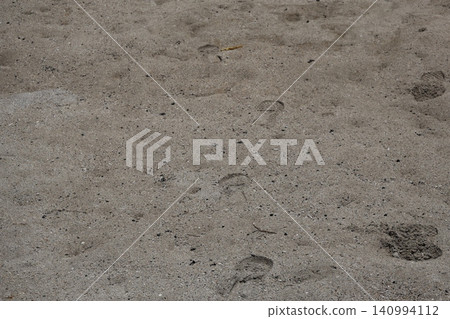 Sandy beach landscape with footprints Sandy beach landscape with footprints 140994112