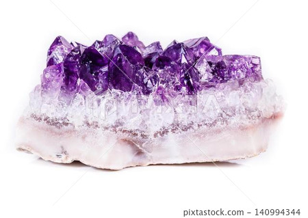 Amethyst crystal cluster on white mineral base with purple hue Amethyst crystal cluster on white mineral base with purple hue 140994344