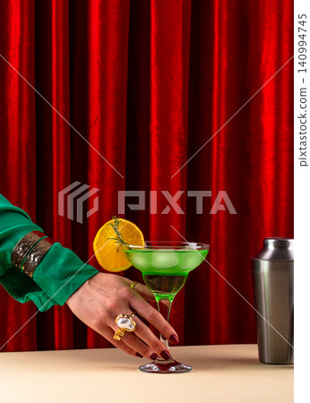 Retro green cocktail against a red curtain Retro green cocktail against a red curtain 140994745