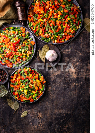 Frozen mix of vegetables on dark background Frozen mix of vegetables on dark background 140994760