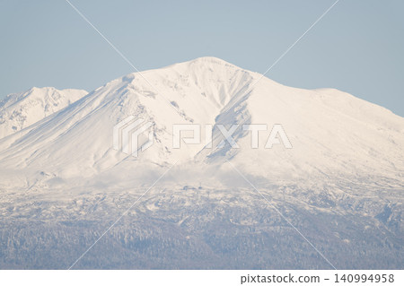 A majestic snow-capped volcano, sending up plumes of snow. A majestic snow-capped volcano, sending up plumes of snow. 140994958