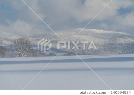 Soft blue snowfields and gentle hills Soft blue snowfields and gentle hills 140994984